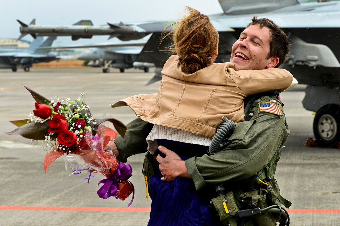 U.S. Navy Lt. Bradley Thompson hugs his girlfriend during a homecoming celebration on Naval Air Facility Atsugi, Japan, Nov. 17, 2012. Thompson is assigned to Strike Fighter Squadron 195, which completed a deployment aboard the aircraft carrier USS George Washington.  
