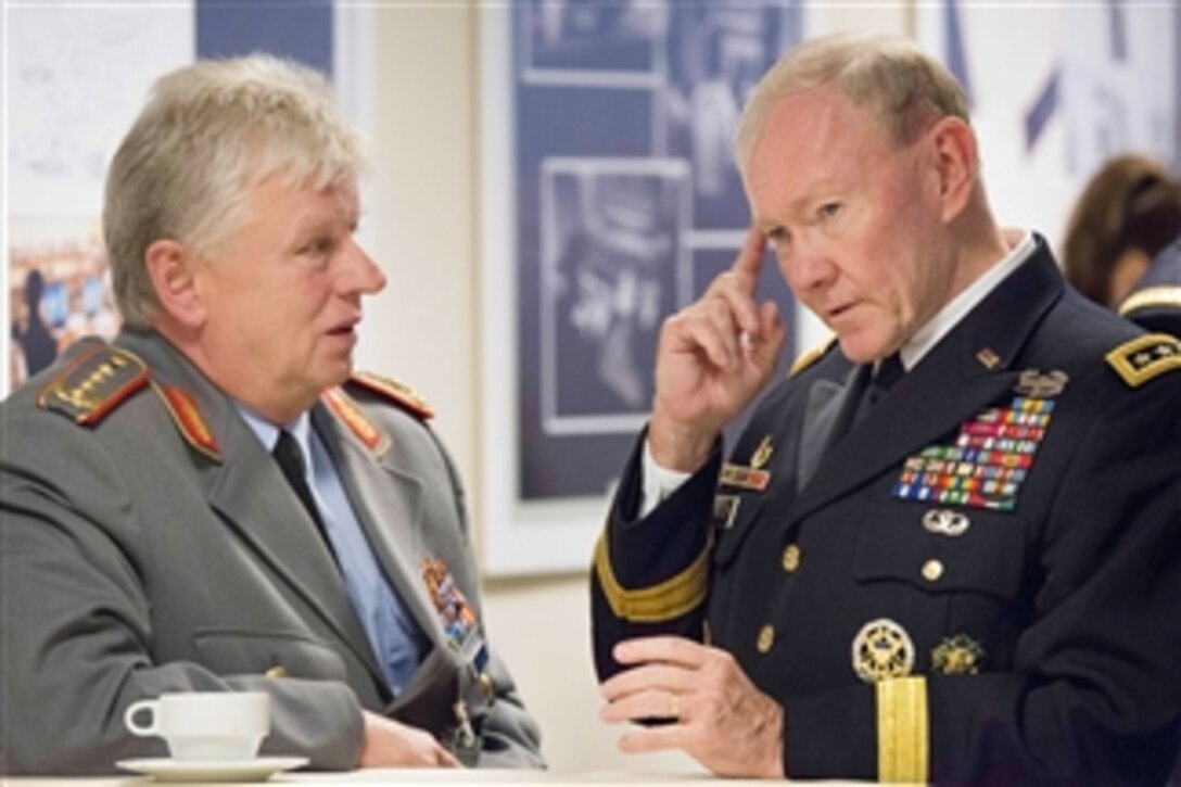 U.S. Army Gen. Martin E. Dempsey, right, chairman of the Joint Chiefs of Staff, speaks with German army Gen. Volker Wieker, chief of staff of the German Armed Forces, during a break from the NATO Chiefs of Defense meetings in Brussels, May 21, 2014. The alliance of 28-member countries discussed current military issues including the way ahead in Afghanistan, Ukraine and future threats. 