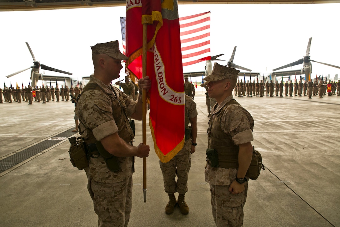 Lt. Col. Christopher M. Murray, left, receives the Marine Medium Tiltrotor Squadron 265 colors from Lt. Col. William L. Depue Jr. May 22 at Marine Corps Air Station Futenma during a change of command ceremony. The transfer of organizational colors symbolizes the transfer of command from Depue to Murray. “As you know, we've had an alliance with the country of Japan for its defense for a number of years,” said Murray. “We owe it to the people of Japan to provide the most capable, technically-advanced platforms that we can, and that's the Osprey.” The MV-22B Osprey is a highly-capable, tiltrotor aircraft which combines the vertical capability of a helicopter with the speed and range of a fixed-wing aircraft. VMM-265 is with Marine Aircraft Group 36, 1st Marine Aircraft Wing, III Marine Expeditionary Force. 