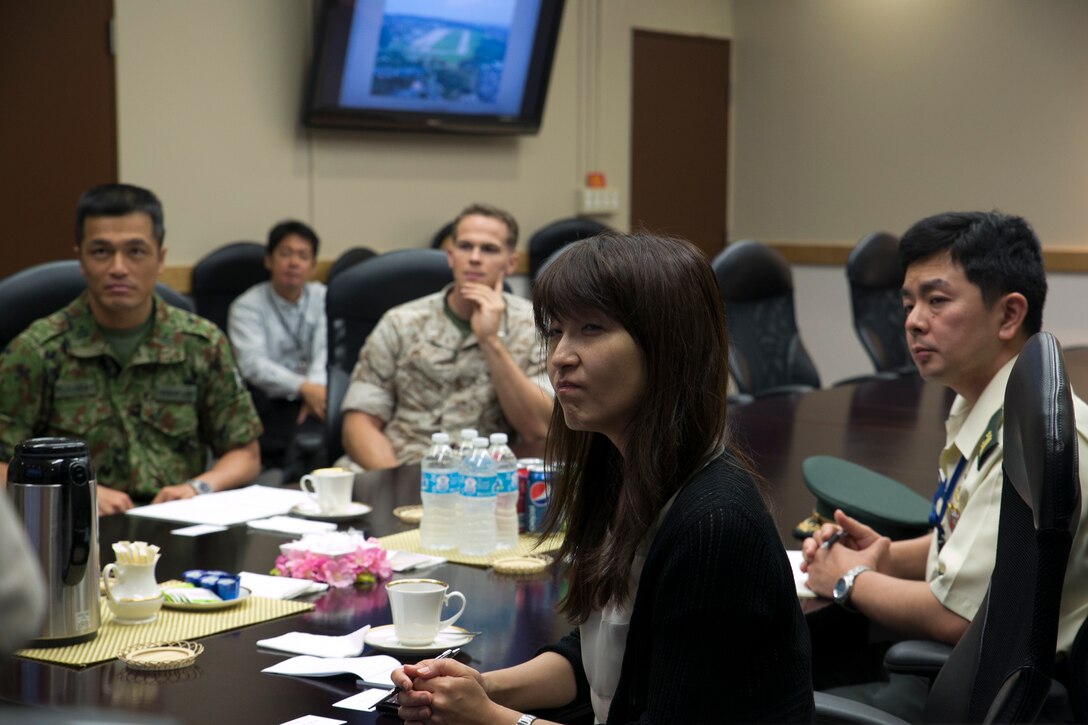 Misa Sakurabayashi, second from right, listens intently to a presentation May 15 alongside U.S. Marine and Japan Ground Self-Defense Force personnel at Marine Corps Air Station Futenma during a tour of the installation. The visit included a formal brief and informal sightseeing at MCAS Futenma and Camp Schwab, along with a hands-on experience in an MV-22B Osprey tiltrotor aircraft flight simulator. Sakurabayashi is a committee member for the Japan Ministry of Defense, and has written numerous works concerning the Japan Self-Defense Force. (U.S. Marine Corps photo by Lance Cpl. Pete Sanders/Released)