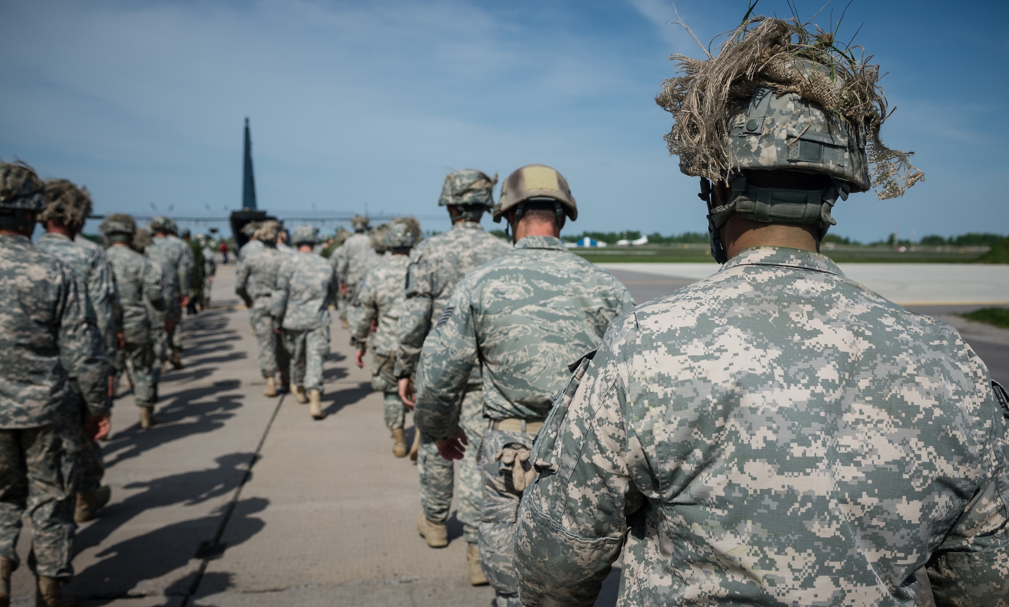 U.S. Airmen and Soldiers prepare to board a 37th Airlift Squadron C-130J Super Hercules alongside Lithuanian paratroopers at Šiauliai International Airport, Lithuania, May 17, 2014. Pilots and loadmasters from the 37th AS alongside an 86th Aircraft Maintenance Squadron crew chief spent four days across three Baltic countries assisting in personnel drops of allied partners and American service members. (U.S. Air Force photo/Airman 1st Class Jordan Castelan)