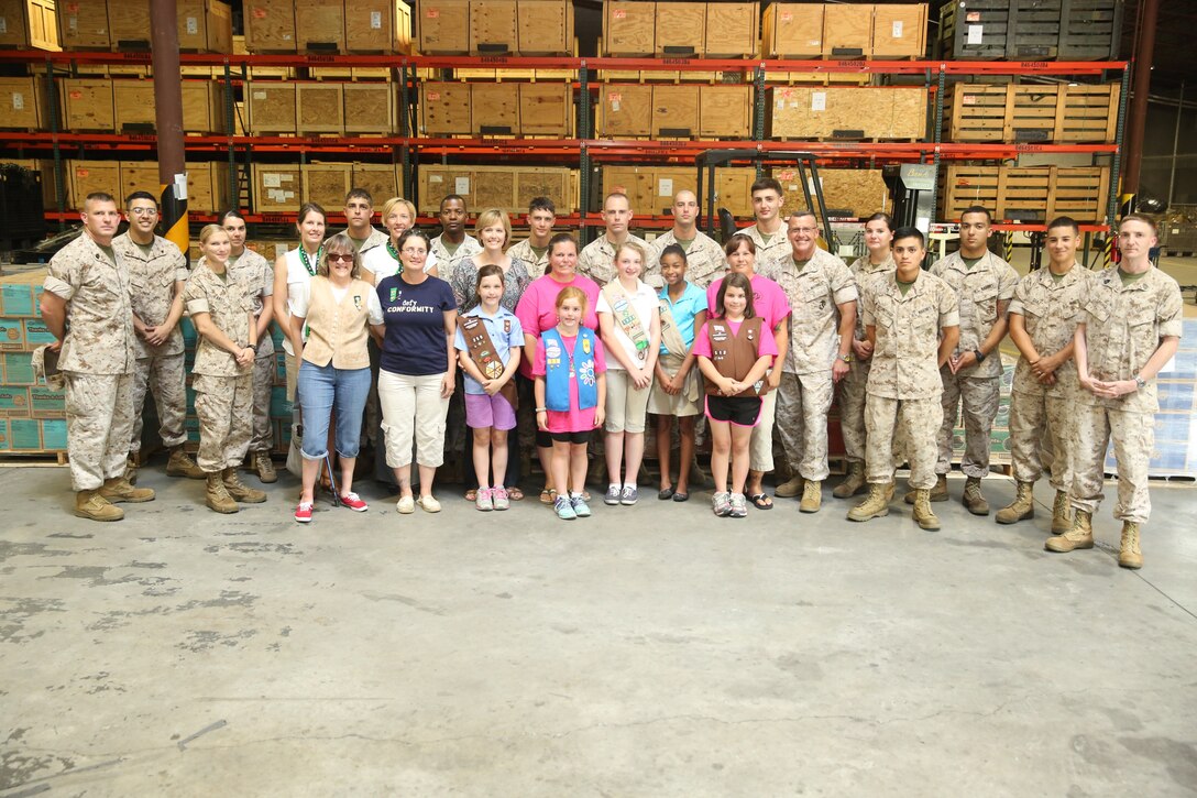 Marines and North Carolina Girl Scouts gather for a photo in front of more than 7,000 boxes of cookies May 13 inside the Marine Wing Headquarters Squadron 2 supply building during the Girl Scouts’ annual Operation Cookie Drop. Operation Cookie Drop is a program in which local Girl Scouts deliver cookies to military personnel from Marine Corps Air Station Cherry Point, Fort Bragg and Seymour Johnson Air Force Base. Out of the 82,164 boxes received this year, more than 7,000 boxes of cookies were delivered to the air station for the Marines and Sailors.


