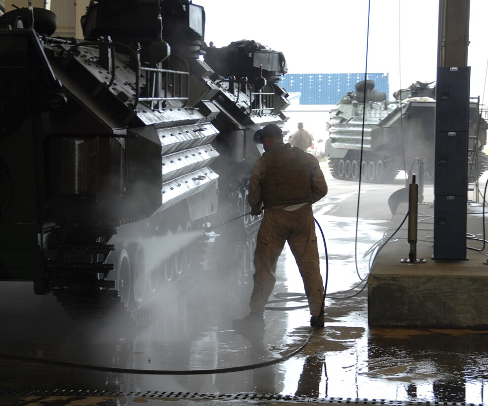 A Marine washes an assault amphibious vehicle after testing its operational capabilities in Marine Corps Support Facility Blount Island’s slipway adjacent to the St. John's River, Jacksonville, Fla., May 15.
