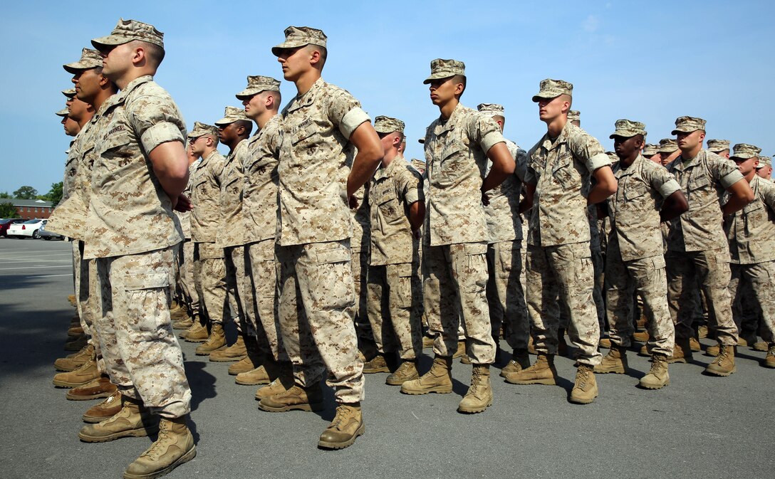 Marines and sailors with 2nd Light Armored Reconnaissance Battalion stand at parade rest before a memorial service held at the battalion headquarters aboard Marine Corps Base Camp Lejeune, N.C., May 21, 2014. The service was a way for Marines, sailors and guests to memorialize their fallen brothers in arms, friends and family.