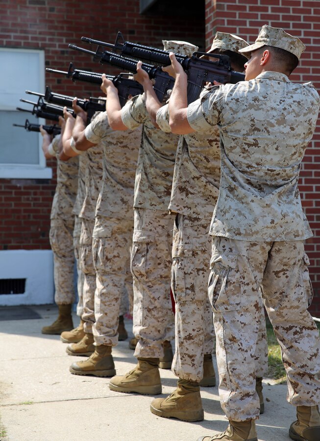 Marines with 2nd Light Armored Reconnaissance Battalion, 2nd Marine Division, render a three-shot volley before the playing of Taps during a memorial service held at the battalion headquarters aboard Marine Corps Base Camp Lejeune, N.C., May 21, 2014. The service included the playing of the national anthem, the Marine’s prayer, playing of Amazing Grace, a three-shot volley and the playing of Taps.