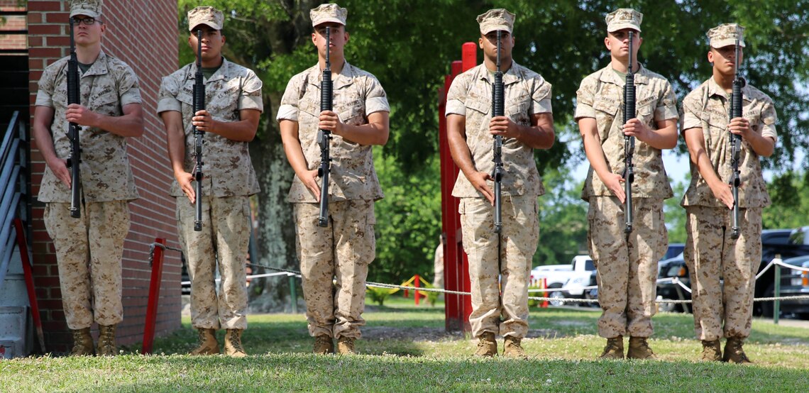 Marines with 2nd Light Armored Reconnaissance Battalion, 2nd Marine Division, stand at present arms for the playing of TAPS during a memorial service held at the battalion headquarters aboard Marine Corps Base Camp Lejeune, N.C., May 21, 2014. The service was a way for Marines, sailors and guests to memorialize their fallen brothers in arms, friends and family.