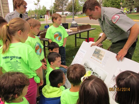 TRINIDAD, COLO., -- Nicholas Bailey explains the importance of dams and how they are built to students during the Trinidad Water Festival, May 15, 2014.