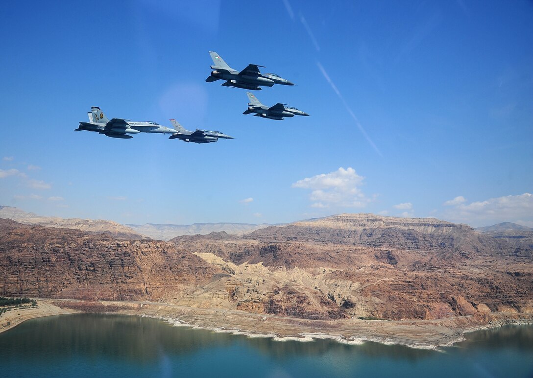 F-16 Fighting Falcons from the U.S. and Royal Jordanian air forces, as well as an F-18 Hornet from the U.S. Marine Corps, fly in formation during Exercise Eager Tiger May 13, 2014, over the Dead Sea in Jordan. Hosted annually in Jordan, the exercise allows fighter pilots and maintainers from around the world to exchange knowledge while increasing interoperability and showing their dedication to regional stability. (U.S. Air Force photo/Staff Sgt. Roidan Carlson)