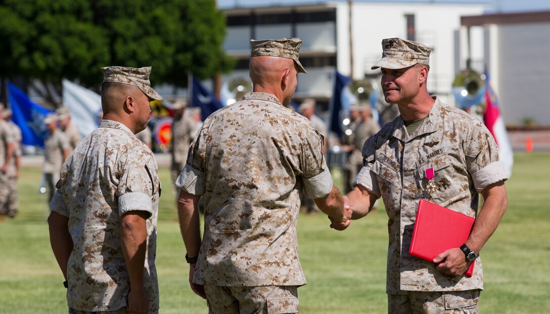 Colonel Bradford Gering is awarded a Legion of Merit for his distinguished tour as the Commanding Officer for Marine Aviation Weapons and Tactics Squadron 1, based out of Marine Corps Air Station Yuma, Ariz., on the station’s parade deck, Thursday. Gering relinquished his duties as MAWTS-1 Commanding Officer to Col. James Adams during the change of command ceremony.