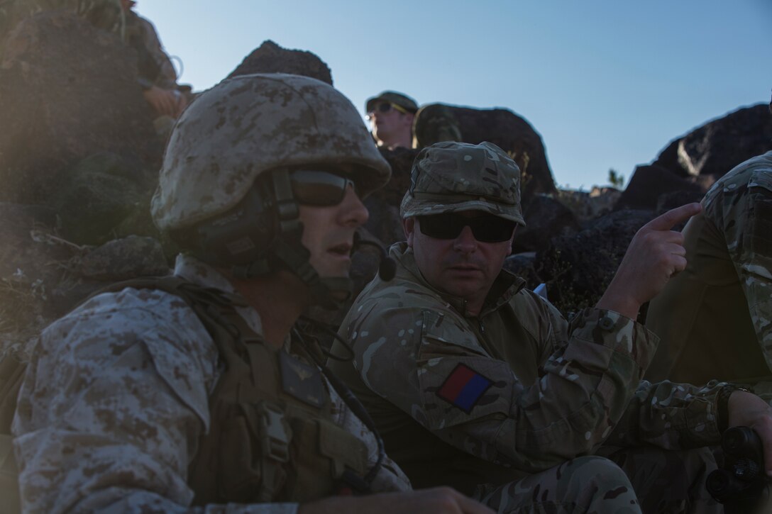 Major Jason Edholm (left), the air officer for 11th Marine Regiment based out of Marine Corps Base Camp Pendleton, Calif., and a San Diego native, coordinates an airstrike with Warrant Officer Class 2 David Cooper (right), a joint terminal attack controller with the United Kingdom Army and a London native, at the Barry M. Goldwater Range, located in Southern Arizona, May 3. The airstrike was part of the United Kingdom’s Crimson Eagle training exercise.