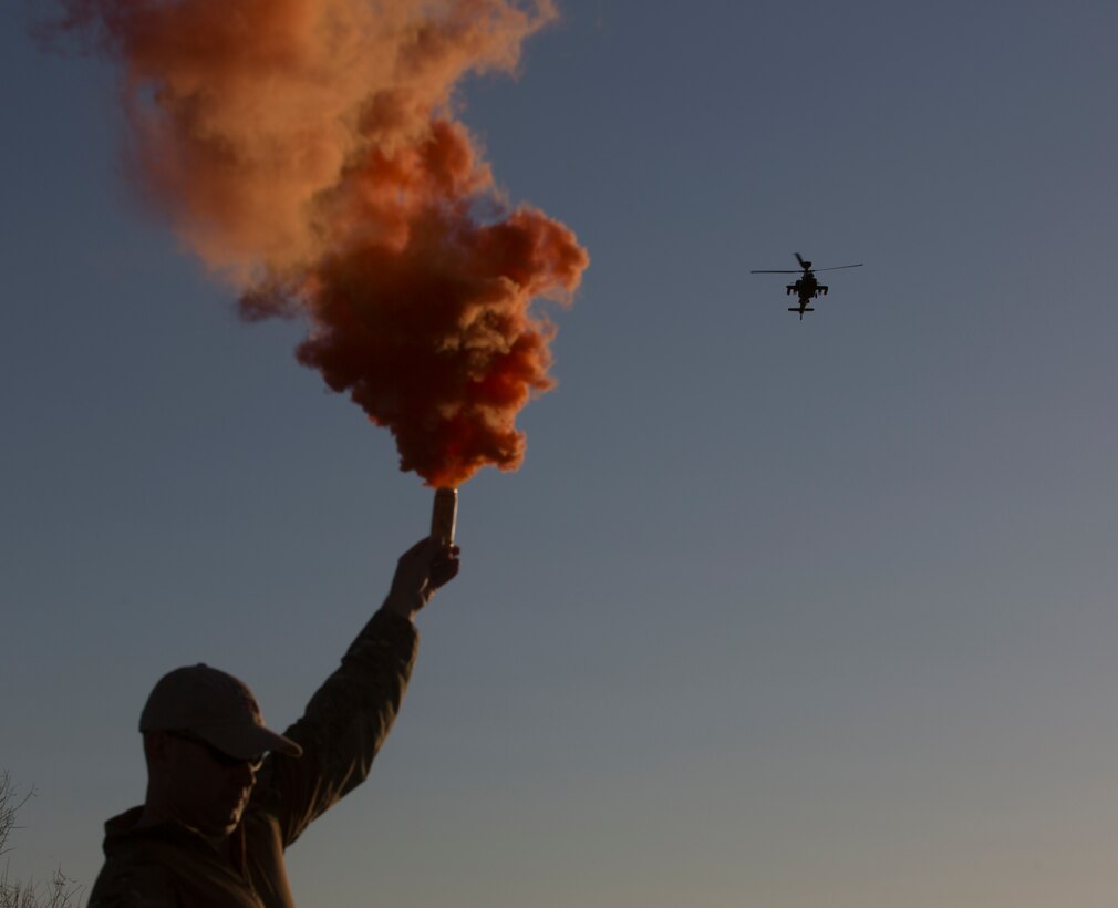 Major Alex Dart, the chief of staff for the United Kingdom Army’s Crimson Eagle exercise, denotes a friendly position by lighting a flare at the Barry M. Goldwater Range, located in Southern Arizona, on May 3.
