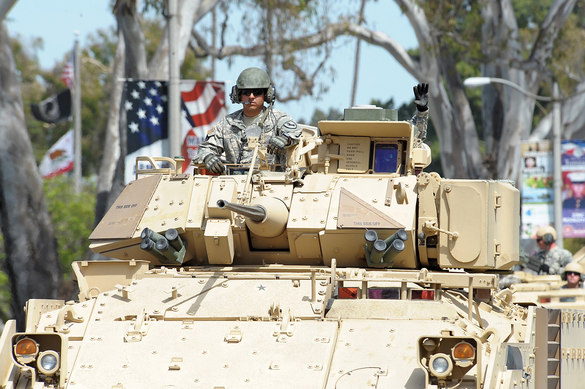 Soldiers from the 11th Army Calvary Regiment, stationed at Fort Irwin, Calif., drive a Bradley fighting vehicle down Torrance Blvd. during the annual Torrance Armed Forces Day parade, May 17. The Bradley and other vehicles were on display at Del Amo Mall.  (Photo by Joe Juarez) 