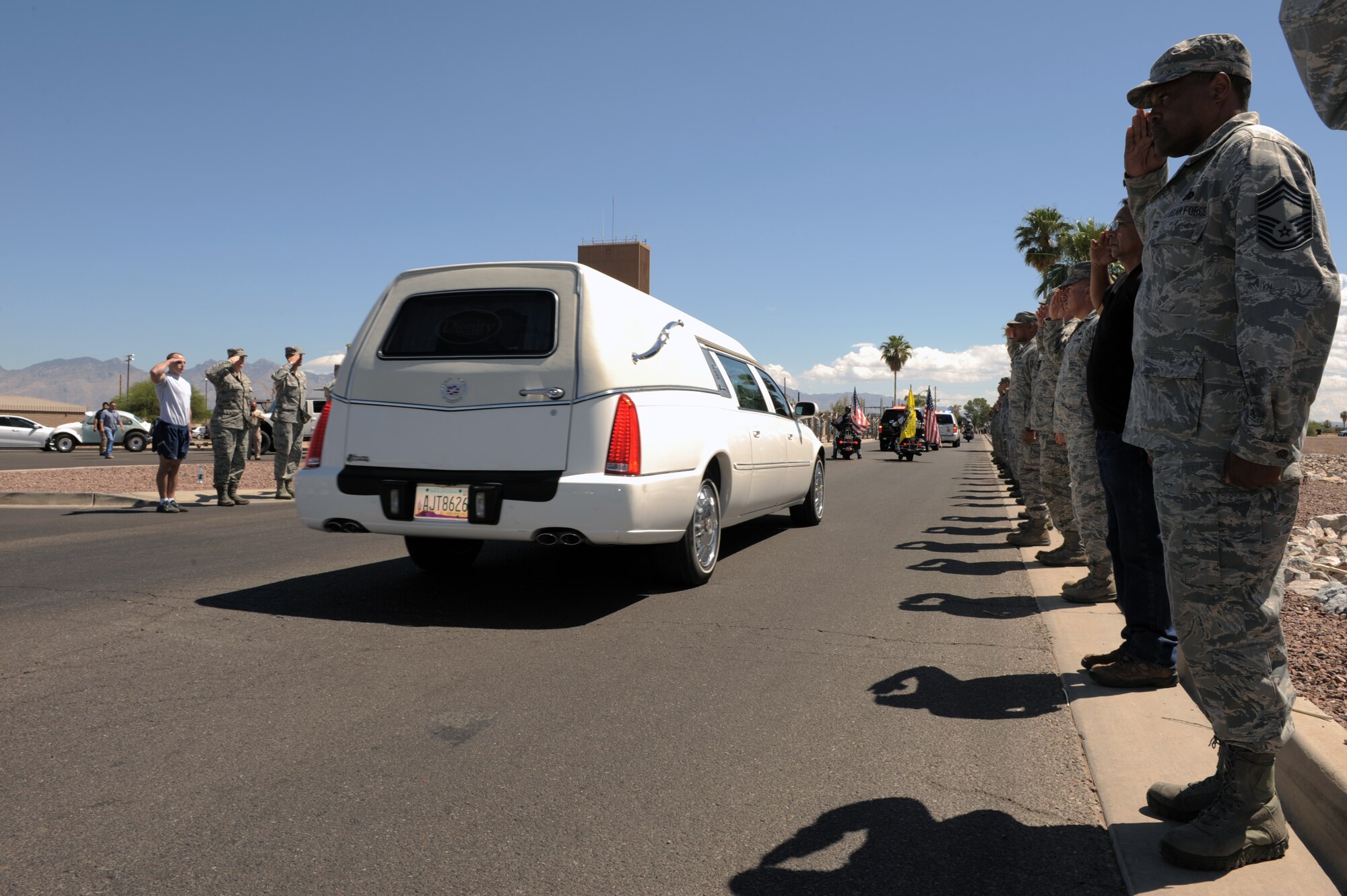 Desert Lightning Team members render a salute as the procession of U.S. Army Command Sgt. Maj. Martin Barreras’ passes by them at Davis-Monthan Air Force Base, Ariz., May 22, 2014. Barreras, a native of Tucson, Ariz., died May 13, in San Antonio Military Medical Center, Joint Base San Antonio, Texas, from wounds suffered on May 6, in Harat Province, Afghanistan, when enemy forces attacked his unit with small arms fire. (U.S. Air Force photo by Airman 1st Class Chris Drzazgowski/Released) 