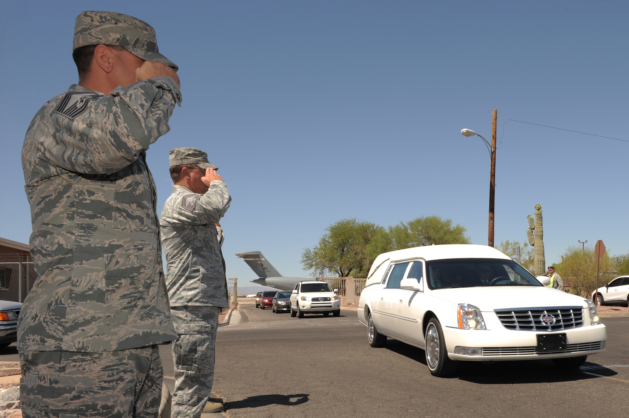 U.S. Air Force Chief Master Sgt. Chad Balance, 355th Medical Group superintendent and Chief Master Sgt. Peter Buzynski, 25th Operational Weather Squadron superintendent salutes U.S. Army Command Sgt. Maj. Martin Barreras’ procession as it drives down Mike Flores Street at Davis-Monthan Air Force Base, Ariz., May 22, 2014. Barreras, a native of Tucson, Ariz., died May 13, in San Antonio Military Medical Center, Joint Base San Antonio, Texas, from wounds suffered on May 6, in Harat Province, Afghanistan, when enemy forces attacked his unit with small arms fire. (U.S. Air Force photo by Airman 1st Class Chris Drzazgowski/Released) 
 
