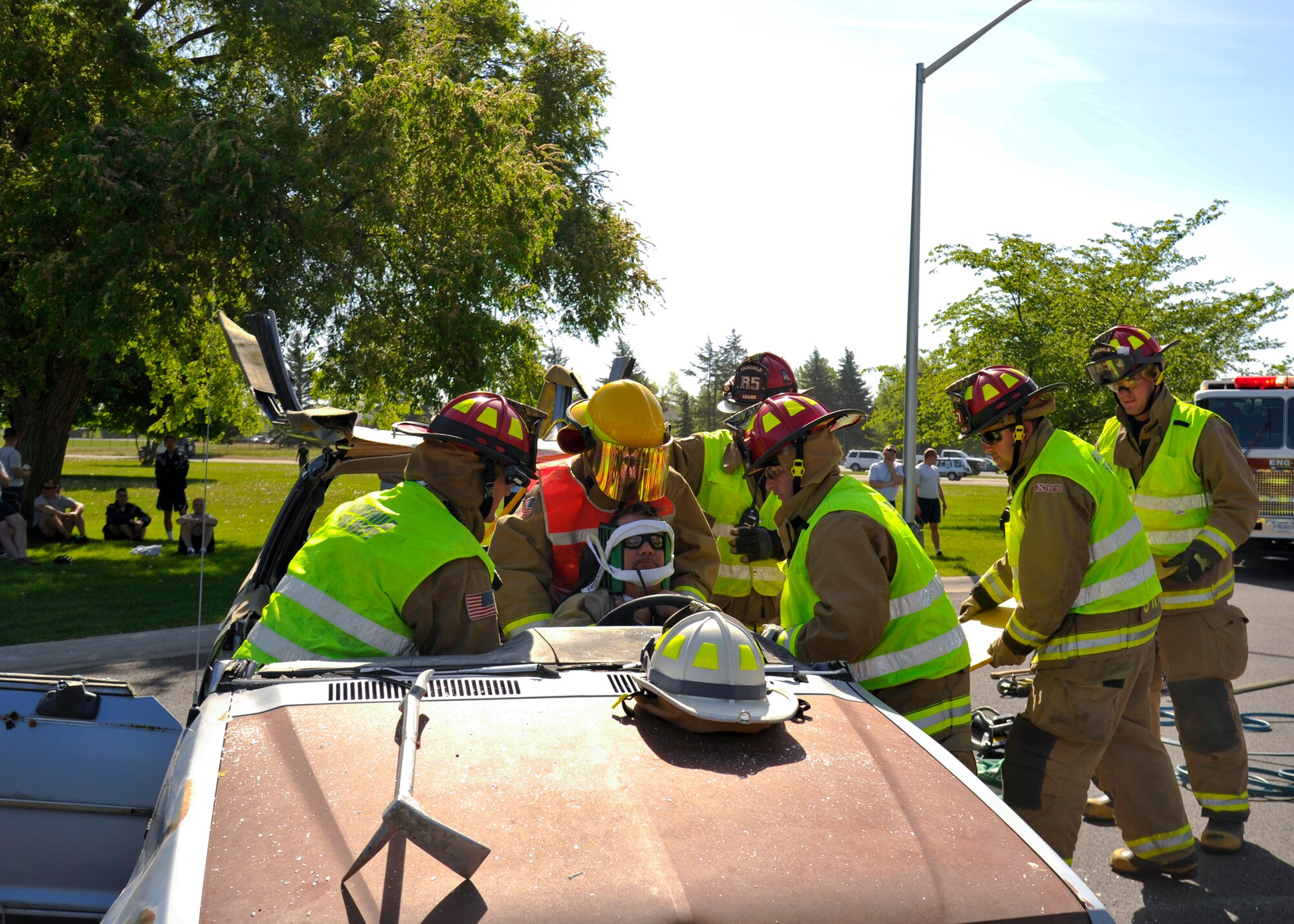 Members of the 92nd Civil Engineer Squadron fire department, perform a mock jaws of life demonstration during the Critical Days of Summer kickoff event at Fairchild Air Force Base, Wash., May 22, 2014. (U.S. Air Force photo by Staff Sgt. Michael Means/Released)