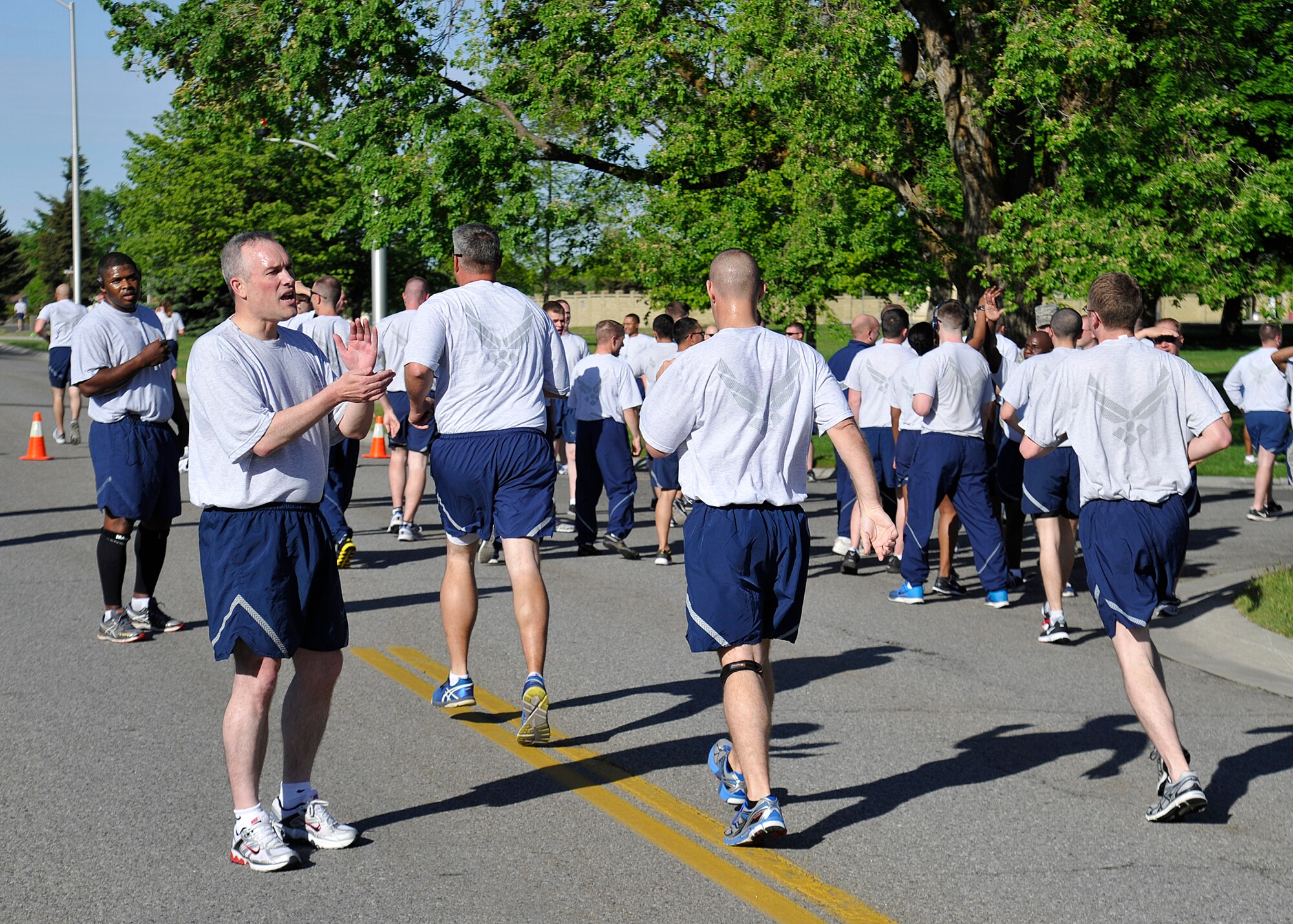 Col. Brian Newberry, 92nd Air Refueling Wing commander, encourages Airmen as they finish the Wing Run during the Critical Days of Summer kickoff event at Fairchild Air Force Base, Wash., May 22, 2014. (U.S. Air Force photo by Staff Sgt. Michael Means/Released)