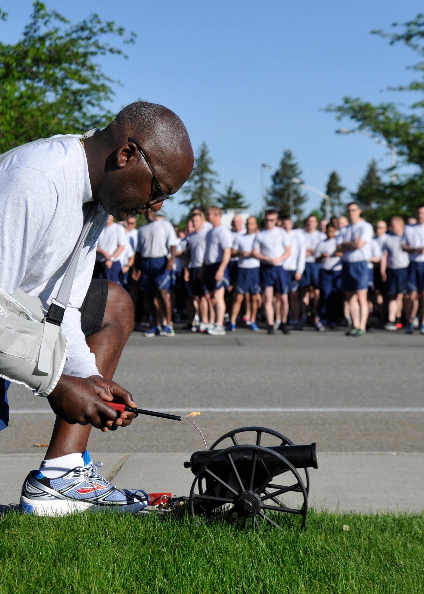 Chief Master Sgt. Rufus Love, 92nd Maintenance Group superintendent, lights the ceremonial cannon to mark the begining of the wing run during the Critical Days of Summer kickoff event at Fairchild Air Force Base, Wash., May 22, 2014. (U.S. Air Force photo by Staff Sgt. Michael Means/Released)
