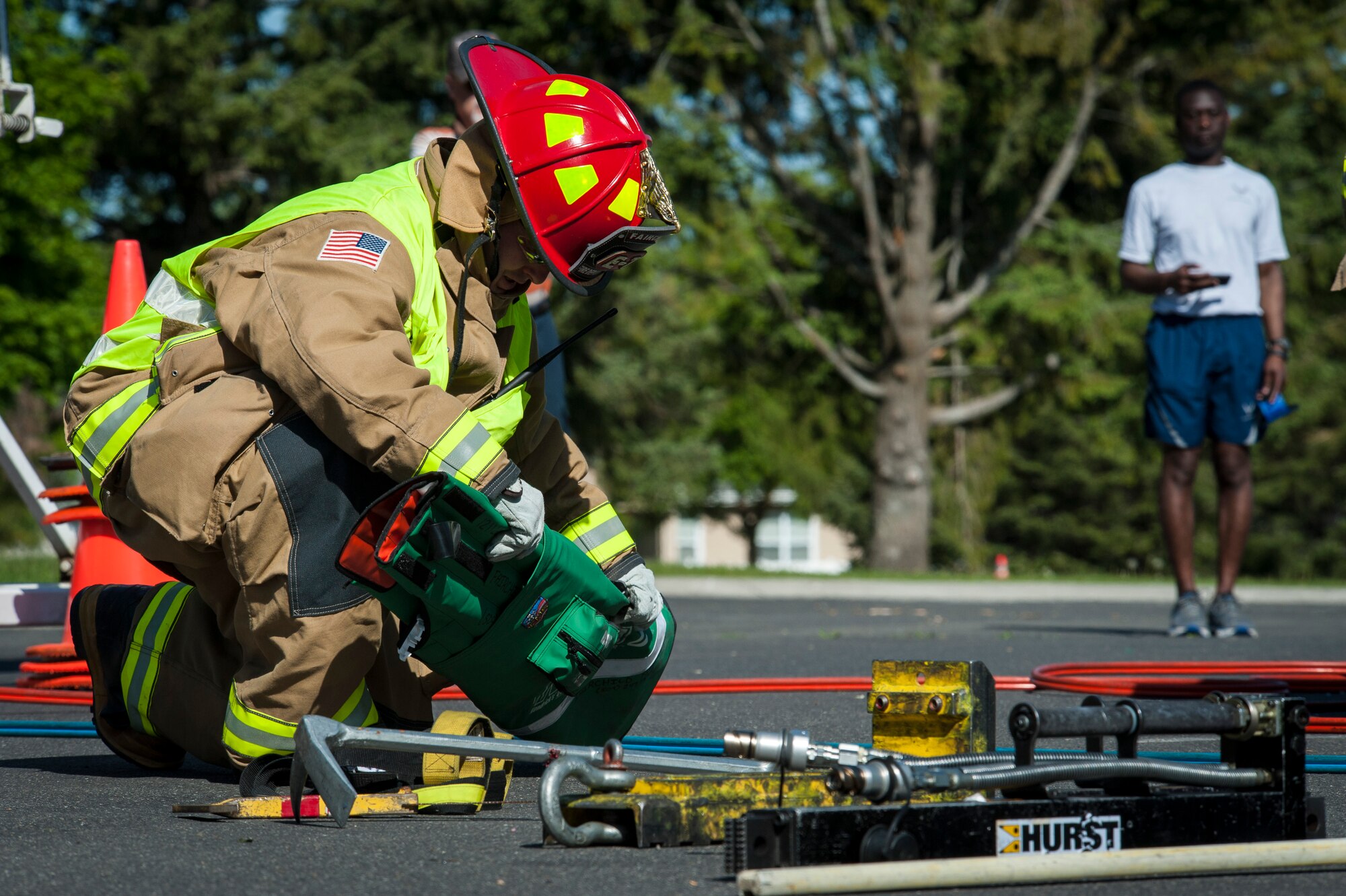 Fairchild Firefighters demonstrate how to operate the "Jaws of Life" extraction tool during the Critical Days of Summer kickoff event at Fairchild Air Force Base, Wash., May 22, 2014. This year's CDS theme is "Risk: Double Checks; Not Second Thoughts," calling for family, friends and coworkers to act as the final barrier between a good time and a life-impacting disaster. (U.S. Air Force photo by Staff Sgt. Benjamin W. Stratton/Released)