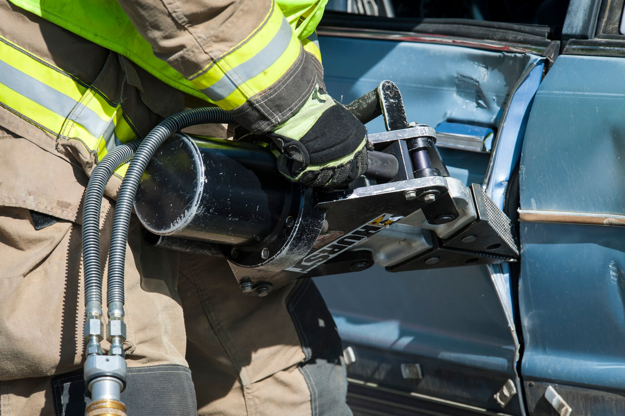 Fairchild Firefighters demonstrate how to operate the "Jaws of Life" extraction tool during the Critical Days of Summer kickoff event at Fairchild Air Force Base, Wash., May 22, 2014. This year's CDS theme is "Risk: Double Checks; Not Second Thoughts," calling for family, friends and coworkers to act as the final barrier between a good time and a life-impacting disaster. (U.S. Air Force photo by Staff Sgt. Benjamin W. Stratton/Released)