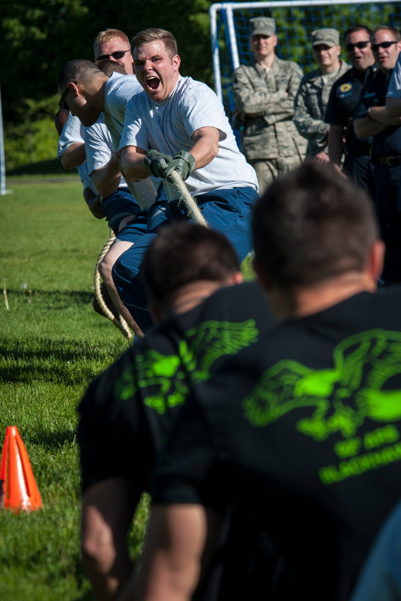 93rd Air Refueling Squadron Airmen pull their counterparts from the 92nd Air Refueling Squadron across the line while participating in the tug-of-war challenge during the Critical Days of Summer kickoff event at Fairchild Air Force Base, Wash., May 22, 2014. The 92nd Civil Engineer Squadron "Dirt Boys" won the competition. This year's CDS theme is "Risk: Double Checks; Not Second Thoughts," calling for family, friends and coworkers to act as the final barrier between a good time and a life-impacting disaster. (U.S. Air Force photo by Staff Sgt. Benjamin W. Stratton/Released)
