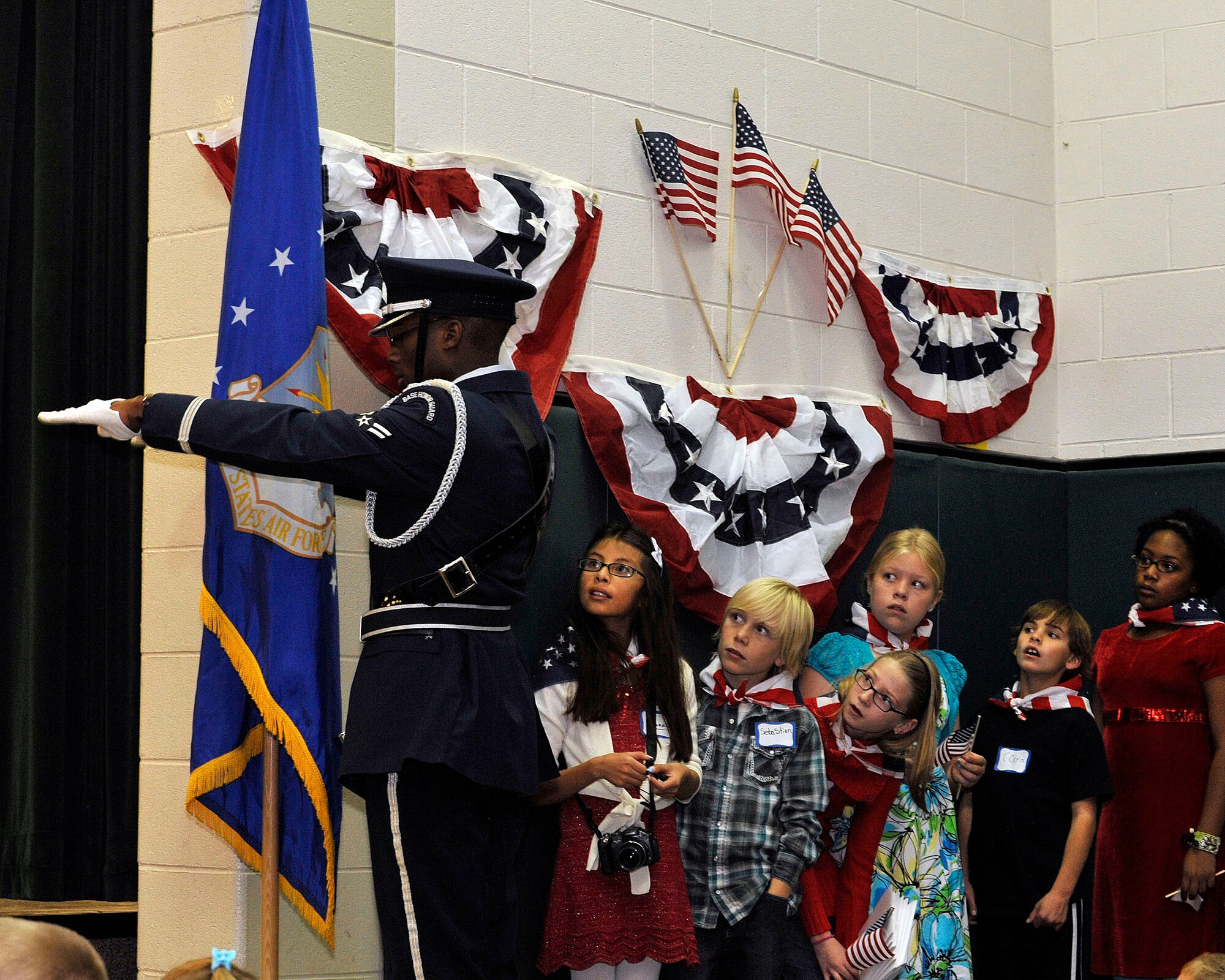 U.S. Air Force Airman First Class Antonio Brooks, Mile High Honor Guard, dresses the U.S. Air Force flag during a Veterans Day salute at Dakota Valley Elementary School in Aurora, Colo. The base honor guard performs final military honors at nearly 570 funerals per year and is the face of the United States Air Force to many families who have lost their loved ones. (U.S. Air Force photo by Tech. Sgt. Wolfram Stumpf/Released)
