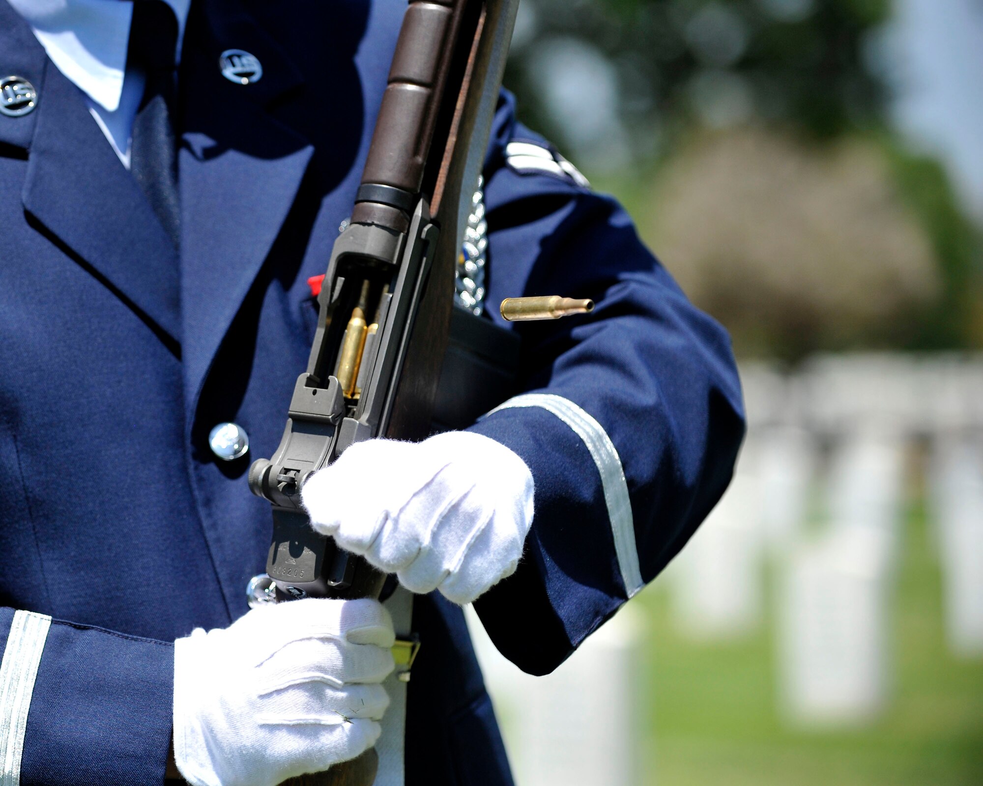 A U.S. Air Force Mile High Honor Guard Airmen charges his ceremonial rifle during a three volley salute July 11, 2012, at Fort Logan National Cemetery in Denver. The base honor guard performs final military honors at nearly 570 funerals per year and is the face of the United States Air Force to many families who have lost their loved ones. (U.S. Air Force photo by Tech. Sgt. Wolfram Stumpf/Released)
