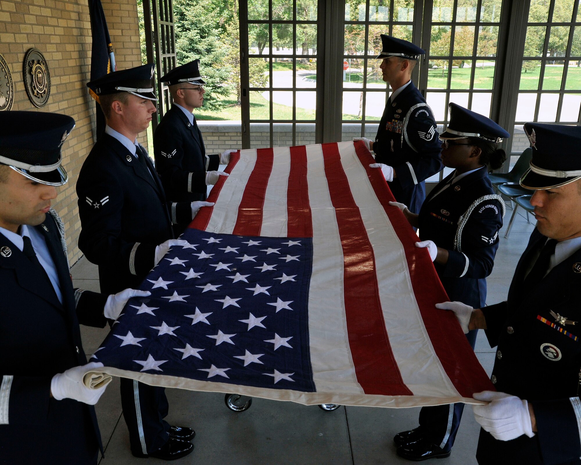 U.S. Air Force Mile High Honor Guard Airmen provide a 6 member flag fold during military funeral honors July 11, 2012, at Fort Logan National Cemetery in Denver. The base honor guard performs final military honors at nearly 570 funerals per year and is the face of the United States Air Force to many families who have lost their loved ones. (U.S. Air Force photo by Tech. Sgt. Wolfram Stumpf/Released)