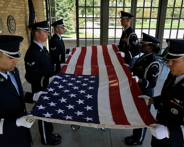 U.S. Air Force Mile High Honor Guard Airmen provide a 6 member flag fold during military funeral honors July 11, 2012, at Fort Logan National Cemetery in Denver. The base honor guard performs final military honors at nearly 570 funerals per year and is the face of the United States Air Force to many families who have lost their loved ones. (U.S. Air Force photo by Tech. Sgt. Wolfram Stumpf/Released)