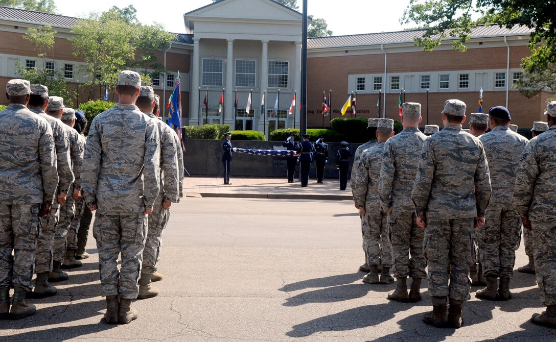 Columbus Air Force Base Airmen stand at attention while the flag is folded during a Memorial Day retreat ceremony on base, May 22, 2014. Formerly known as Decoration day, the men and women who died while serving in the United States Armed Forces are remembered every year on the final Monday of May. Memorial Day originated after the American Civil War to commemorate the Union and Confederate soldiers who died. (U.S. Air Force photo/ Sharon Ybarra)