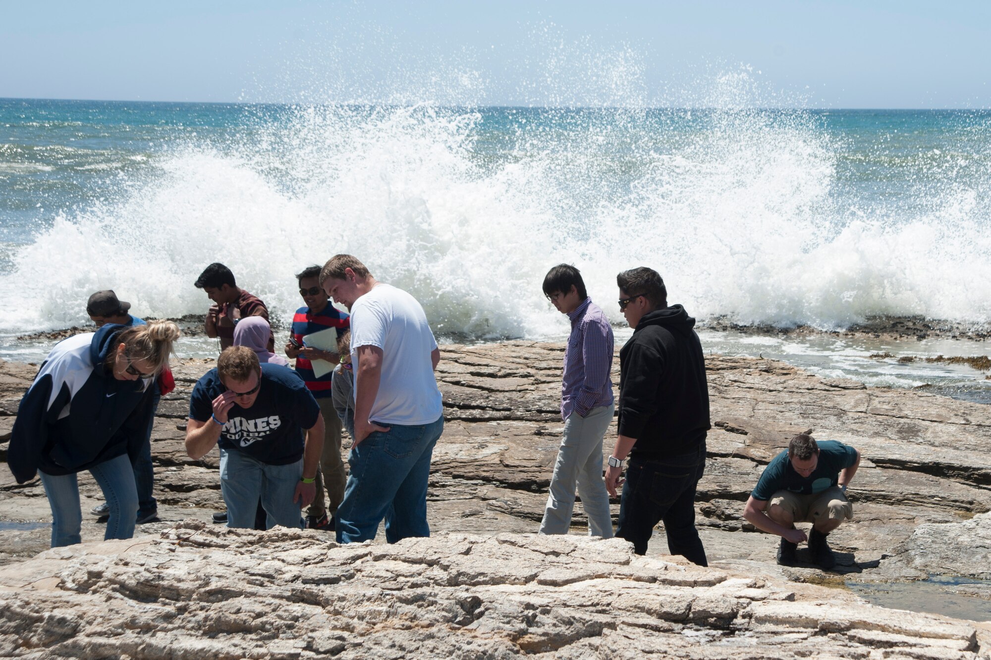 Students observe petroleum rock fractures at Lompoc Landing during a 10 day trip along the coast of California, May 19, 2014, Vandenberg Air Force Base, Calif. Students spent the days visiting petroleum sites and learning about what their future career field entails. (U.S. Air Force Photo by Airman 1st Class Yvonne Morales/ Released)