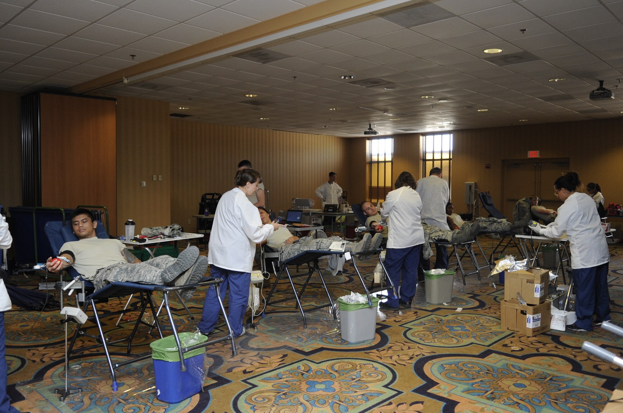 U.S. Air Force Airmen donate blood to the American Red Cross during a blood drive at Davis-Monthan Air Force Base, Ariz., May 21, 2014. More than 50 Desert Lightning Team members gathered at the Mirage Club to give blood to the American Red Cross. (U.S. Air Force photo by Airman 1st Class Betty R. Chevalier/Released)