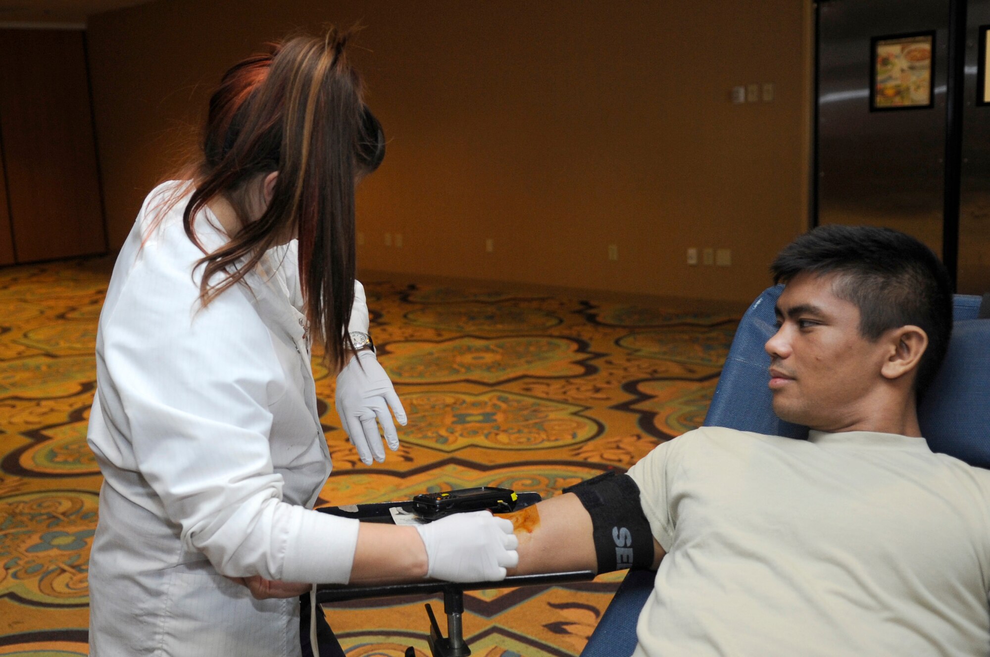 U.S. Air Force Airman 1st Class Matthew Nguyen, 354th Aircraft Maintenance Unit avionics specialist, prepares to donate blood during a blood drive hosted by Davis-Monthan Air Force Base, Ariz., May 21, 2014. Sixty pints of blood were collected during the drive. (U.S. Air Force photo by Airman 1st Class Betty R. Chevalier/Released)