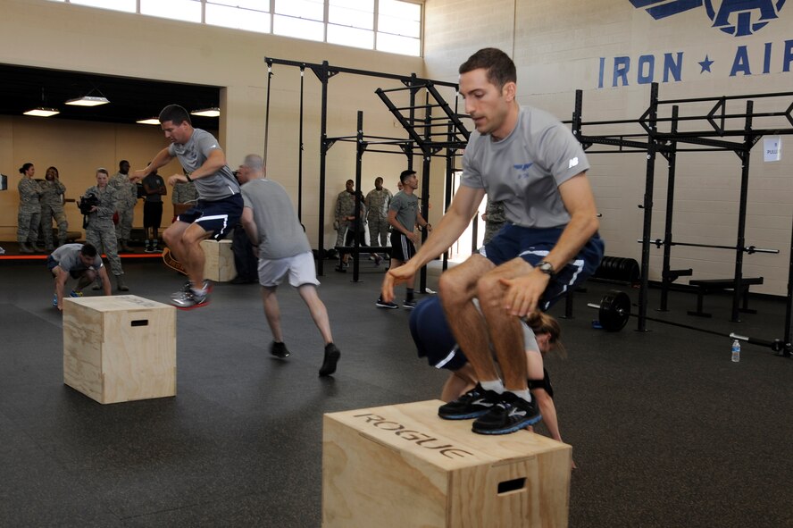 Airmen participate in the “21 Gun Salute” workout at the newly opened Iron Airman Fitness Center on Barksdale Air Force Base, La., May 22, 2014. This was the first official group workout at the new facility, which honored our Nation’s Warriors past, present and future. The workout consisted of a 400 meter run, 21 push-ups, 21 box jumps, 15 burpees and 9 pull-ups. (U.S. Air Force photo/Tech. Sgt. Marie Brown)