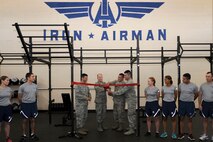 Left to right: Col. Andrew Gebara, 2nd Bomb Wing commander, Lt. Gen. Stephen Wilson, Air Force Global Strike commander, Staff Sgt. Jose Arriaga, and Senior Airman Pashala Lewis, 2nd Civil Engineer Squadron, cut a ribbon commemorating the opening of the new Iron Airman Fitness Center at Barksdale Air Force Base, La., May 22, 2014. Around 70 Airmen contributed to the renovation of the nearly 60 year-old building, formerly the Airman Leadership School Gymnasium. (U.S. Air Force photo/Tech. Sgt. Marie Brown)