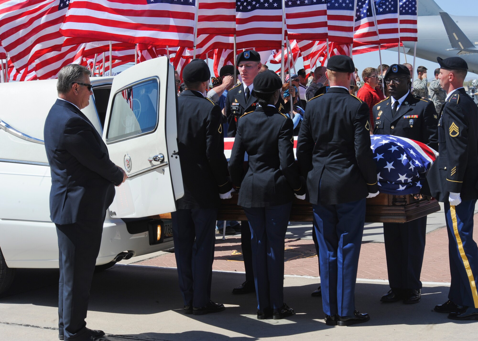 U.S. Army Fort Huachuca Select Honor Guard prepares to place the remains of Command Sgt. Maj. Martin Barreras in a hearse at Davis-Monthan Air Force Base, Ariz., May 22, 2014. Barreras died May 13, in San Antonio Military Medical Center, Joint Base San Antonio, Texas, from wounds suffered on May 6, in Harat Province, Afghanistan, when enemy forces attacked his unit with small arms fire. (U.S. Air Force photo by Senior Airman Sivan Veazie/Released)