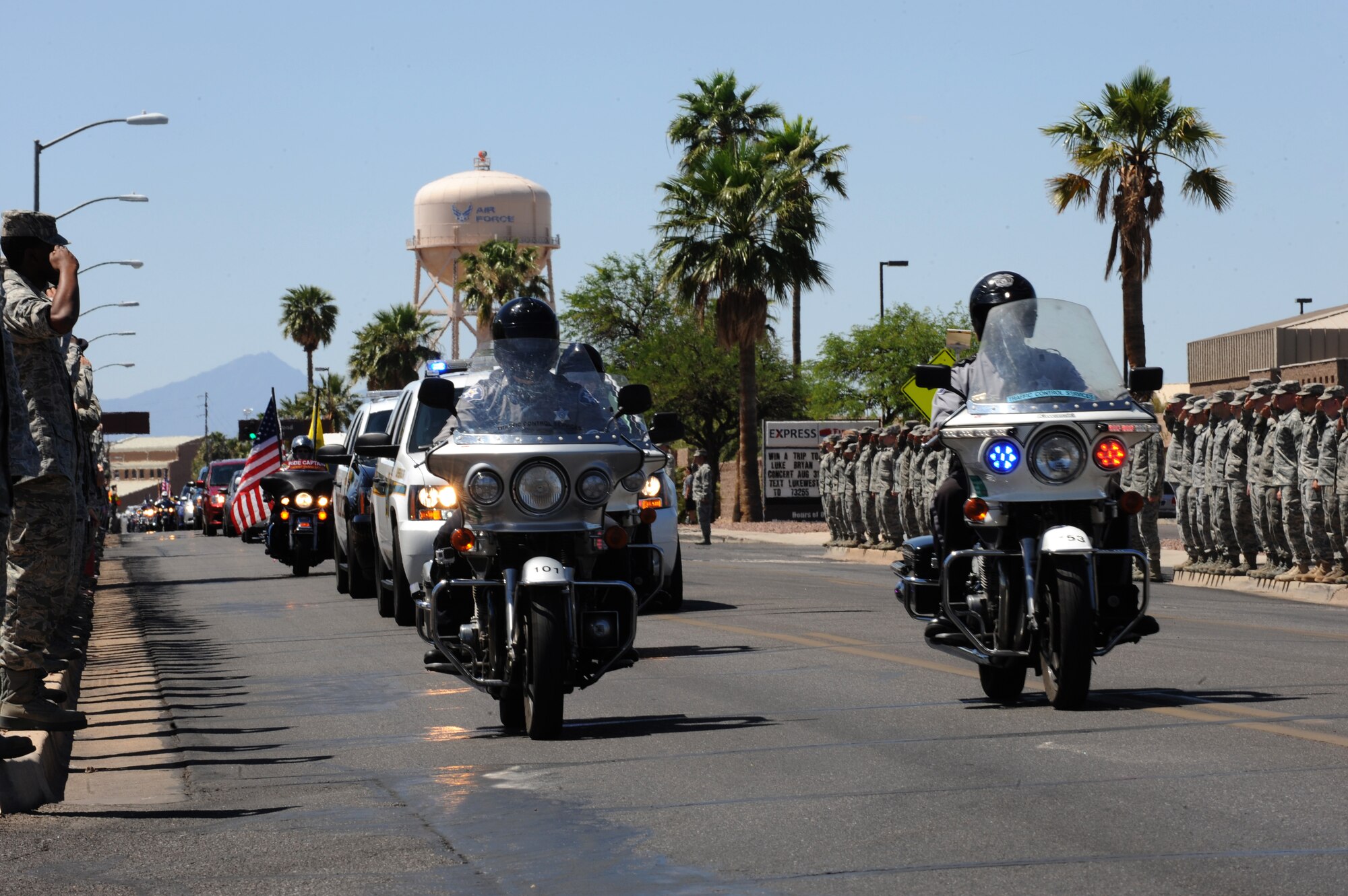 Desert Lightning Team members render a salute while the remains of U.S. Army Command Sgt. Maj. Martin R. Barreras are escorted by the Pima County Sheriff’s department, Tucson Police department and the Patriot Guard Riders at Davis-Monthan Air Force Base, Ariz., May 22, 2014. Barreras, a native of Tucson, Ariz., died May 13, in San Antonio Military Medical Center, Joint Base San Antonio, Texas, from wounds suffered on May 6, in Harat Province, Afghanistan, when enemy forces attacked his unit with small arms fire. (U.S. Air Force photo by Airman 1st Class Cheyenne Morigeau/Released)