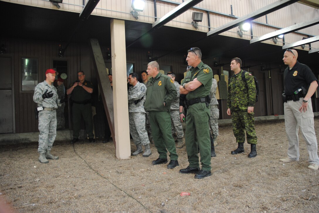 Staff. Sgt. Randy Shear, 319th Security Forces Combat Arms instructor, explains the layout of the targets for the 2014 Police Week Commanders’ Shoot held May 15, 2014, at the firing range on Grand Forks Air Force Base, N.D. The shooting copetition was also an opportunity for 319th SFS members to promote and foster working relationships with other law enforcement agencies in the surrounding area. (U.S. Air Force photo/Staff Sgt. Luis Loza Gutierrez)
