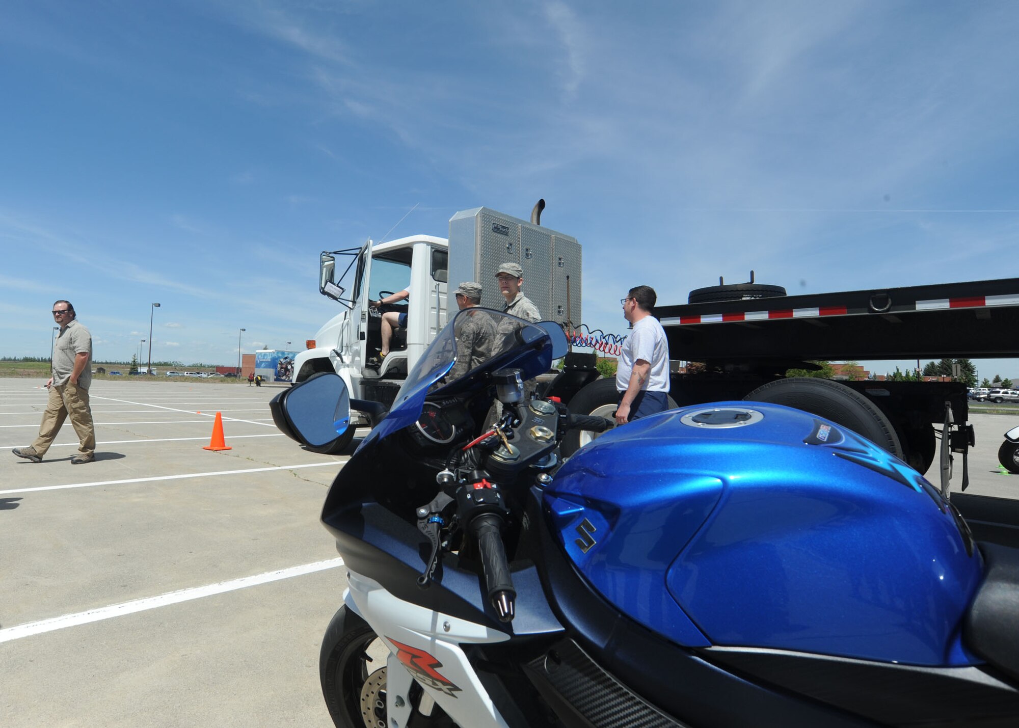 A motorcycle sits in the blind spot of a semi-truck during a motorcycle safety demonstration at Fairchild Air Force Base, Wash., May 22, 2014. The vehicles simulated real-life driving hazards for the Critical Days of Summer kickoff event. (U.S. Air Force photo by Airman 1st Class Sam Fogleman/Released)