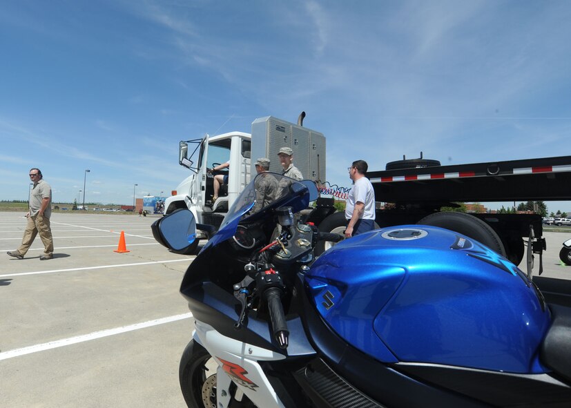 A motorcycle sits in the blind spot of a semi-truck during a motorcycle safety demonstration at Fairchild Air Force Base, Wash., May 22, 2014. The vehicles simulated real-life driving hazards for the Critical Days of Summer kickoff event. (U.S. Air Force photo by Airman 1st Class Sam Fogleman/Released)