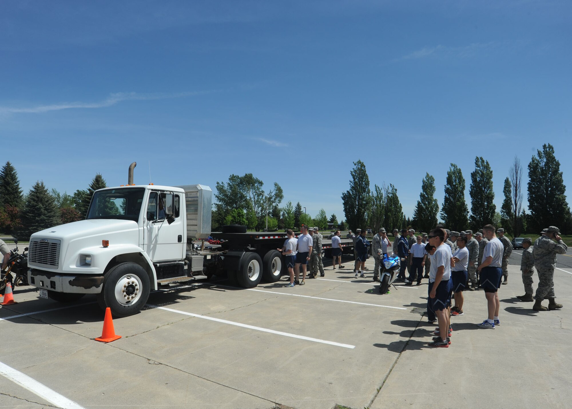Members of Team Fairchild take part in a motorcycle safety demonstration at Fairchild Air Force, Base, Wash., May 22, 2014. The display was a simulation of how motorcycles can easily be lost in blind spots of large vehicles and part of the Critical Days of Summer kickoff event. (U.S. Air Force photo by Airman 1st Class Sam Fogleman/Released)