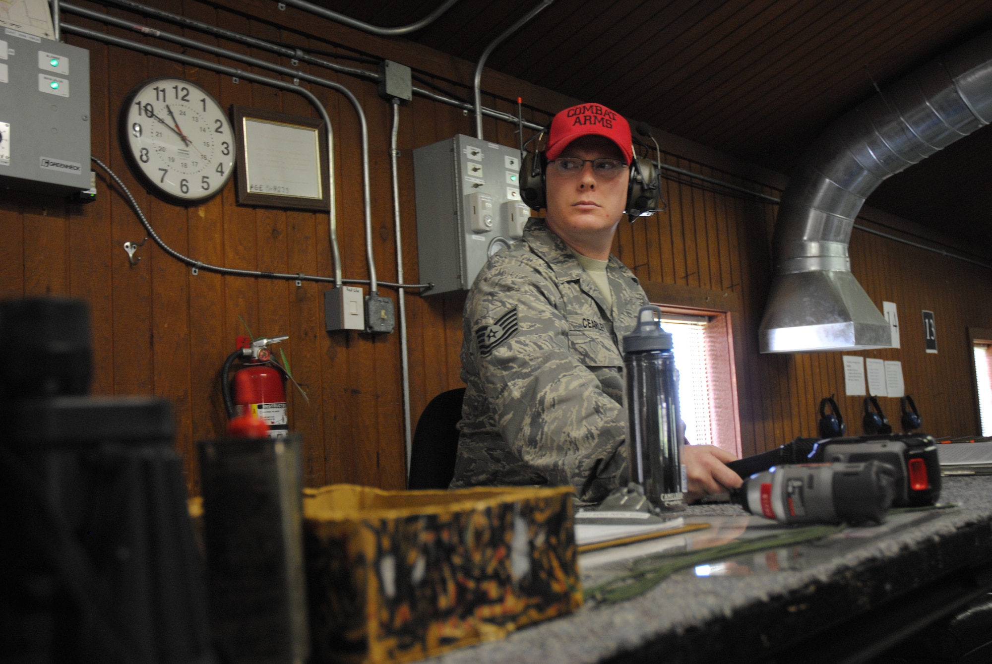 Tech. Sgt. Caleb Cearley, 319th Security Forces NCO in charge of Combat Arms, waits for one of the Combat Arms instructors to signal all clear and secure in order to start another round of firing during the 2014 Police Week Commanders’ Shoot held May 15, 2014, at the firing range on Grand Forks Air Force Base, N.D. All shooters were required to obey the Combat Arms instructors orders for safety purposes. (U.S. Air Force photo/Staff Sgt. Luis Loza Gutierrez)