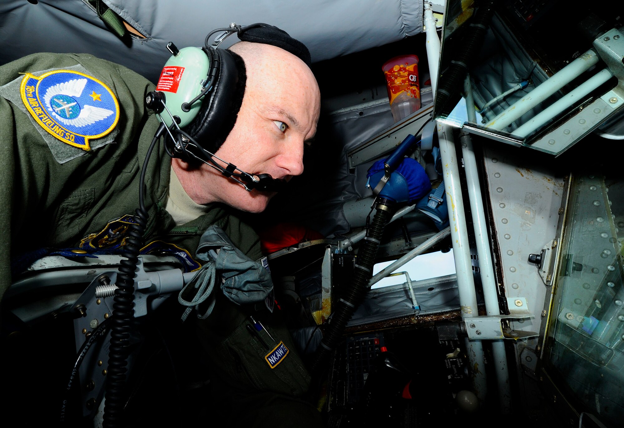 Senior Master Sgt. Ray Lewis, a refueling boom operator assigned to the 931st Air Refueling Group, McConnell Air Force Base, Kan., peers through the window of the refueling pod of a KC-135 Stratotanker while conducting the air refueling of a B-52 Stratofortress from the 307th Bomb Wing, Barksdale Air Force Base, La., during a refueling exercise in the skies over Texas, May 15, 2014. Lewis has been serving as a boom operator for more than 24 years and recently passed 6,500 total flight hours. (U.S. Air Force Photo by Airman 1st Class Victor J. Caputo)