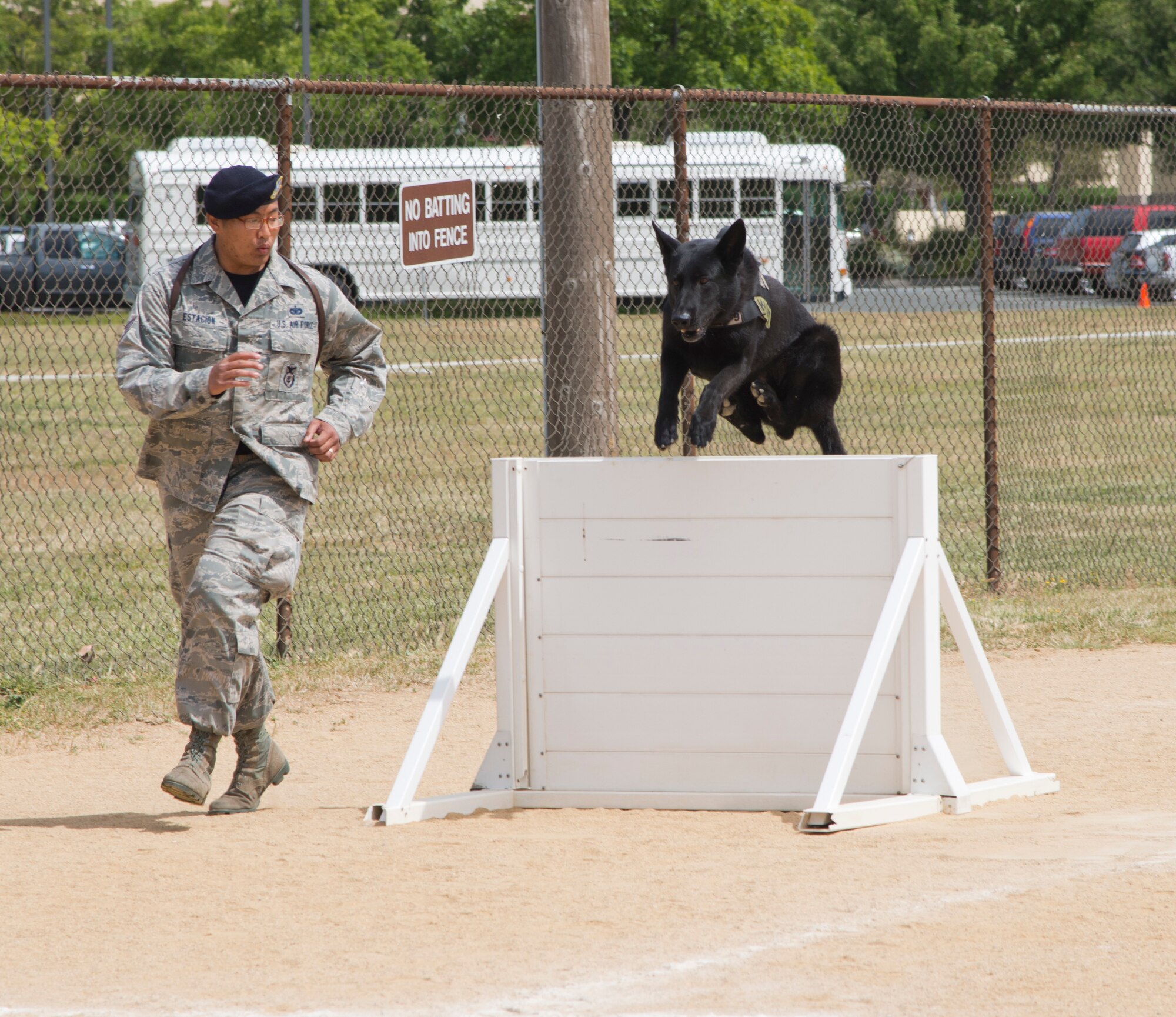 Staff Sgt. Lino Estacion, 60th SFS MWD handler, and Demon, 60th Security Forces MWD, complete a portion of the agility course. (U.S. Air Force photo/Senior Airman Nicole Leidholm)