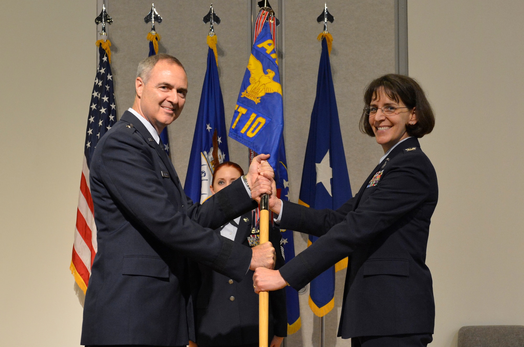 MCGHEE TYSON AIR NATIONAL GUARD BASE, Tenn. - Col. Jessica Meyeraan, right, accepts the guidon of the I.G. Brown Training and Education Center from the Air National Guard Readiness Center's commander, Brig. Gen. R. Scott Williams, during a change-of-command ceremony held in Spruance Hall on May 22, 2014. The formal ceremony signals the official transfer of power from the previous commander, Col. Tim Cathcart, to Meyeraan. (U.S. Air National Guard photo by Master Sgt. Kurt Skoglund/Released)