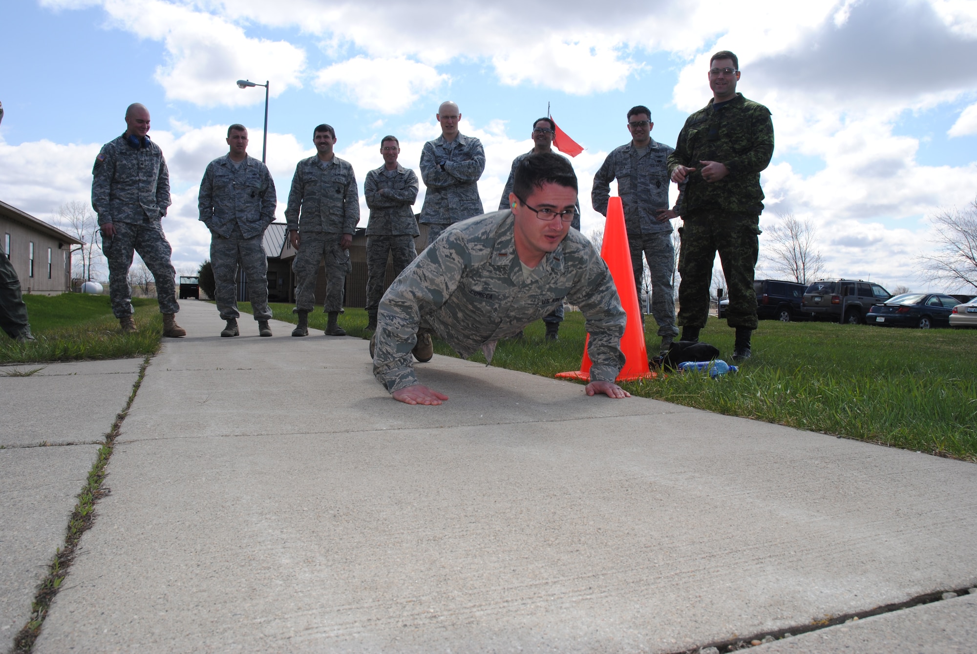 2nd Lt. Juan Correa III, a Spartan from the 10th Space Warning Squadron at Cavalier Air Force Station, N.D., pumps out 20 push-ups during the 2014 Police Week Commanders’ Shoot held May 15, 2014, at the firing range on Grand Forks Air Force Base, N.D. This year’s Police Week shooting competition incorporated stress factors such as physical fatigue and adrenaline rush in order to simulate more of a real-world shooting scenario. (U.S. Air Force photo/Staff Sgt. Luis Loza Gutierrez)