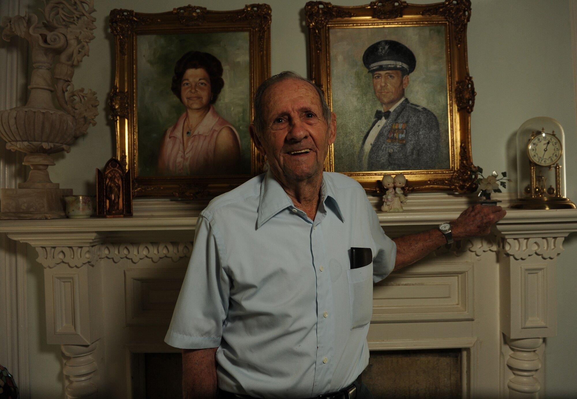 Retired Col. David Fitton poses in front of paintings of himself and his wife May 21, 2014, at his home in Harrison, Ark. Fitton is a veteran of three wars to include World War II, Korea and Vietnam. (U.S. Air Force photo by Airman 1st Class Scott Poe)