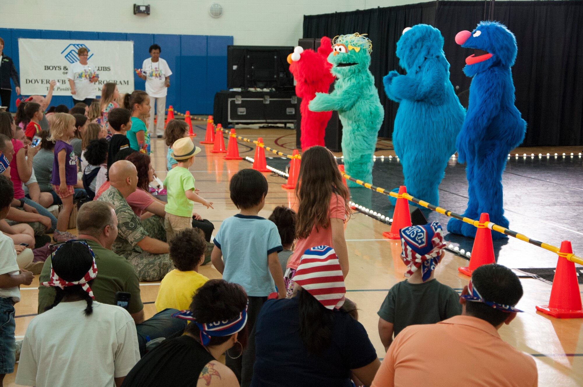 Elmo, Rosita, Cookie Monster and Grover sing to children during Sesame Street live show hosted by the United Service Organization May 22, 2014, at the Youth Center on Dover Air Force Base, Del. The characters used song and dance to shed light on the stressors of military family life, how they affect children and the importance of resiliency.  (U.S. Air Force photo/Senior Airman Jared Duhon)