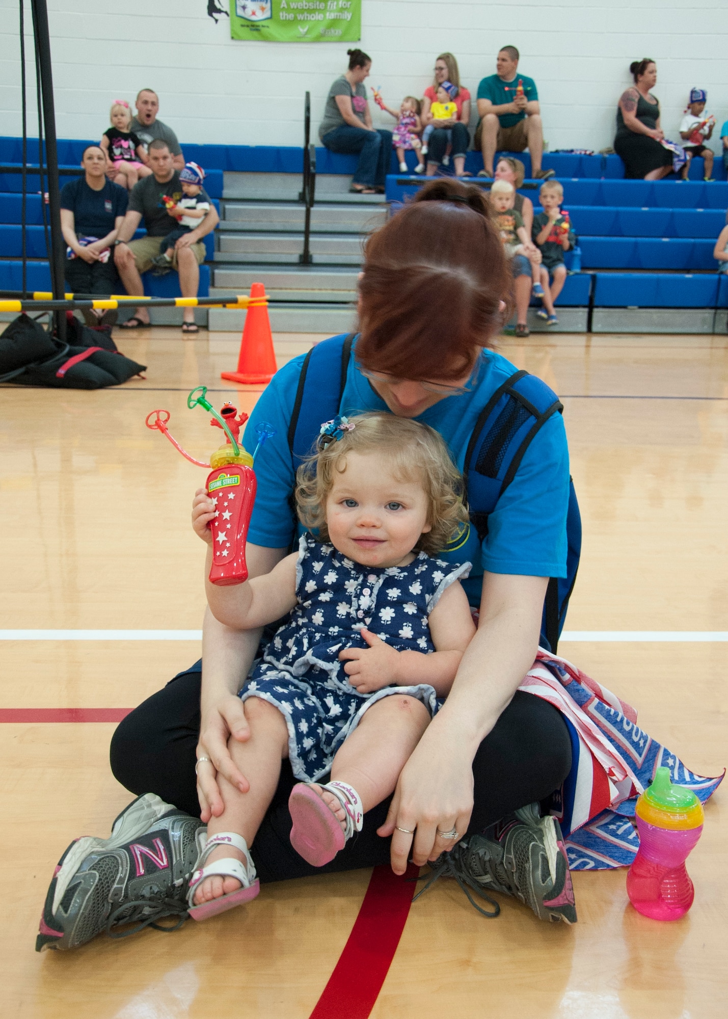 Marjorie Brooks, 436th Force Support Squadron force management journeyman, and her daughter, Amaya, sit excitedly before the start of the Sesame Street live show hosted by the United Service Organization May 22, 2014, at the Youth Center on Dover Air Force Base, Del. The show lasted for 30 minutes with characters from the long standing Sesame Street television show. (U.S. Air Force photo/Senior Airman Jared Duhon) 