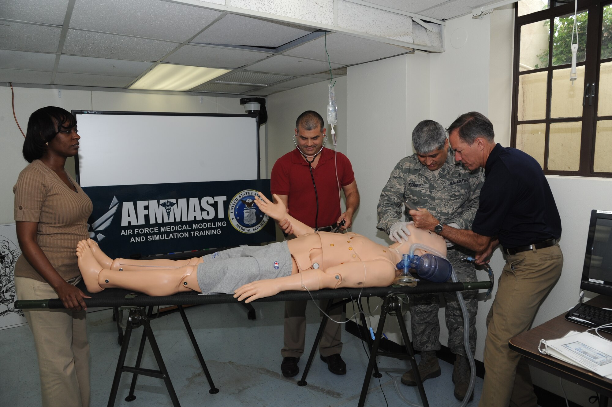 From left: Maya Machacon, Air Force Medical Modeling and Simulation Training curriculum specialist; Ruben Garza, AFMMAST program deputy chief and administrator; Senior Master Sgt. Juan Rodriguez, AFMMAST program manager; and Doug Howard, AFMMAST chief of curriculum, exercise their medical training through simulation with a dummy May 9 at AFMMAST program training room, building 671 at Joint Base San Antonio-Randolph. (U.S. Air Force photo by Airman 1st Class Kenna Jackson)


