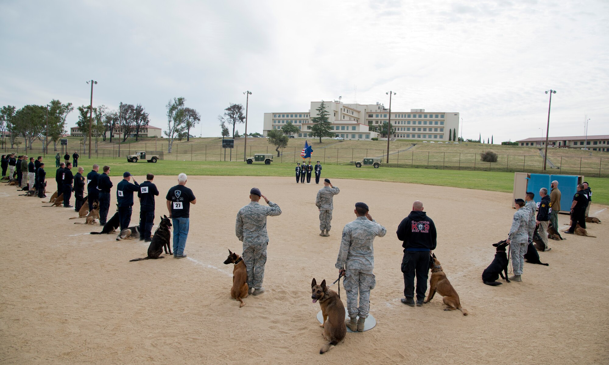 Military and civilian police K-9 handlers gathered on Johnson Filed for the presentation of colors and the National Anthem before the 2014 Defenders K-9 Trials May 17. These trials were the season opener for the Western States Police Canine Association. (U.S. Air Force photo/Senior Airman Nicole Leidholm)